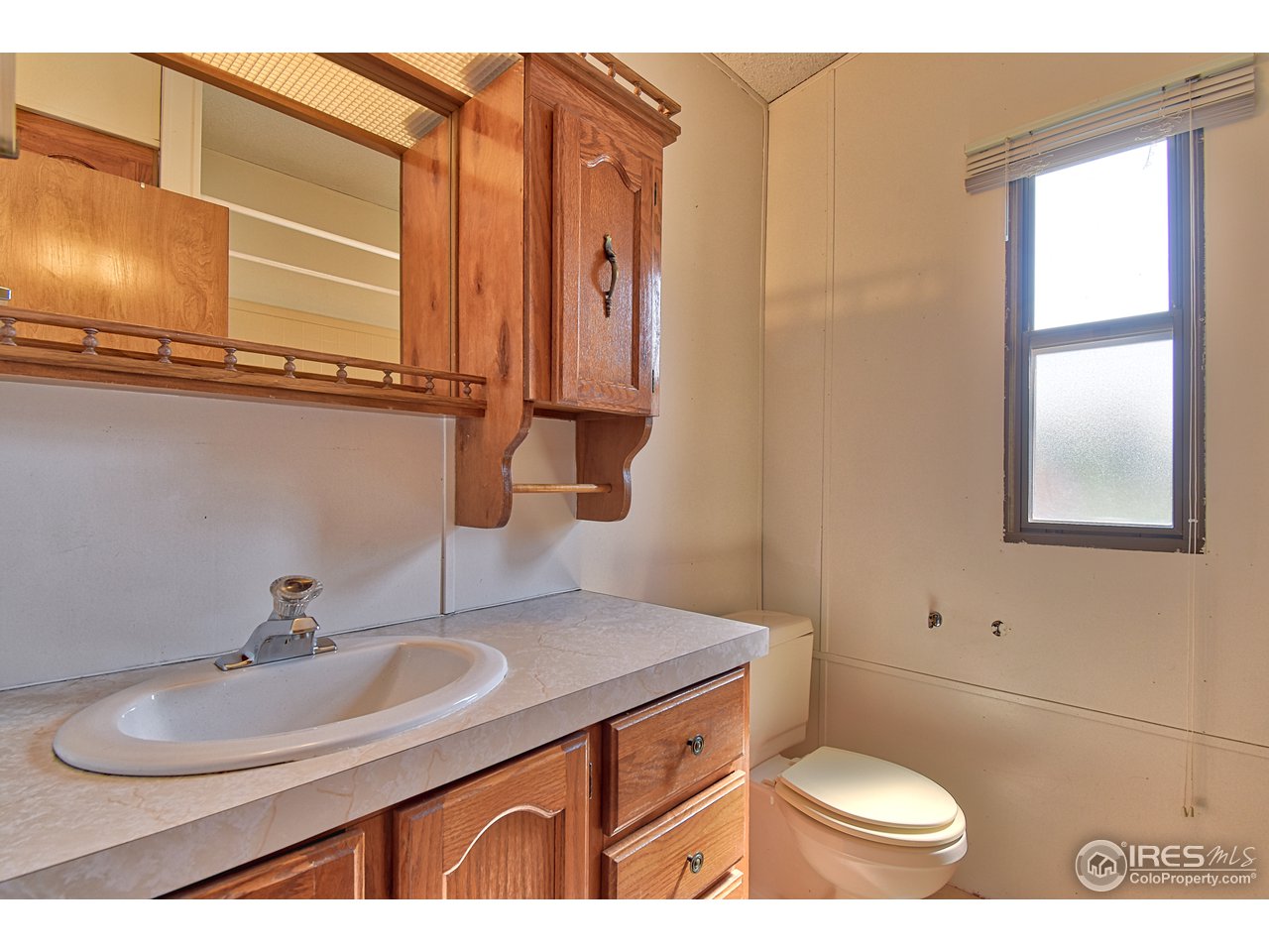 5510 Vallejo Street Denver, CO 80221 - Photo 10 of 22 a bathroom with a sink toilet and mirror