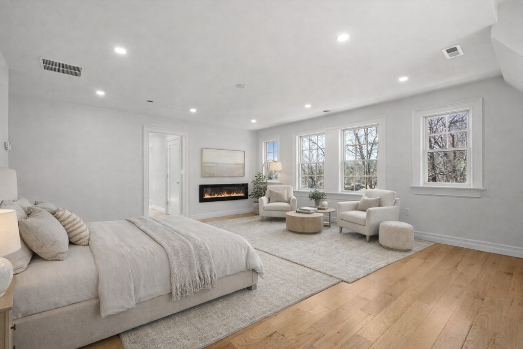 10 Hitching Post Lane Weston, MA 02493 - Photo 24 of 42 a spacious bedroom with a bed a couch and a window