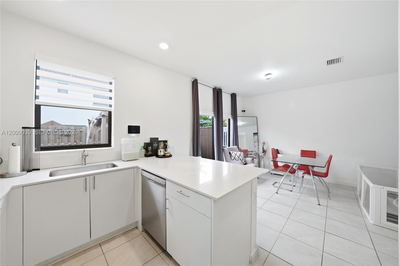 24644 Southwest 118 Court Homestead, FL 33032 - Photo 11 of 33 a kitchen with a sink and chairs