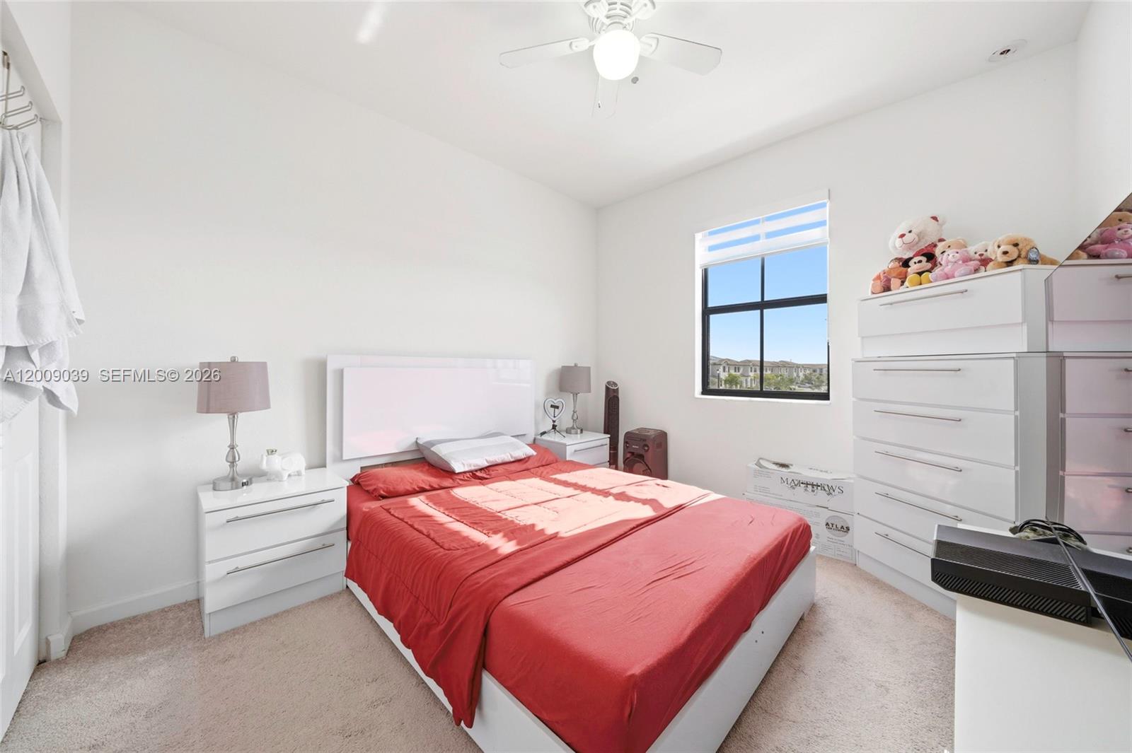 24644 Southwest 118 Court Homestead, FL 33032 - Photo 24 of 33 a bedroom with a bed and a chandelier