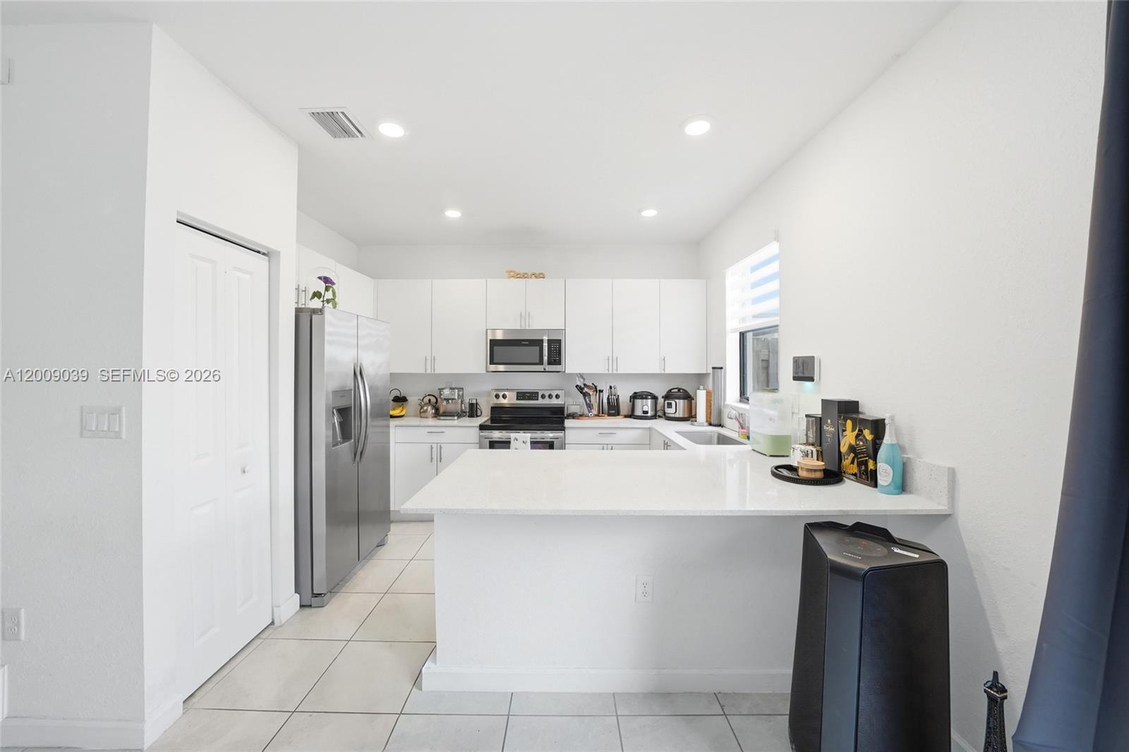 24644 Southwest 118 Court Homestead, FL 33032 - Photo 8 of 33 a living room with stainless steel appliances furniture a refrigerator and a kitchen view