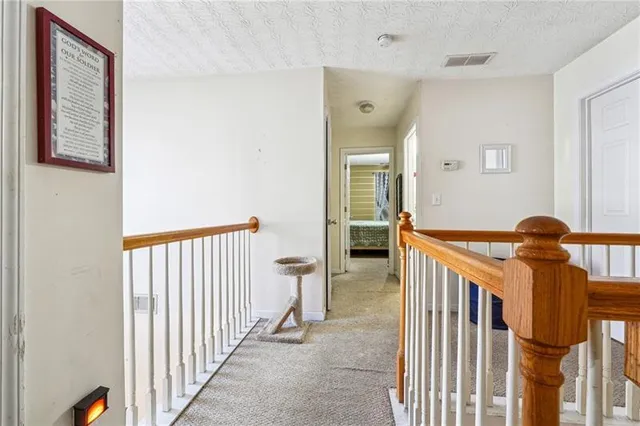 a view of a hallway with windows and entryway