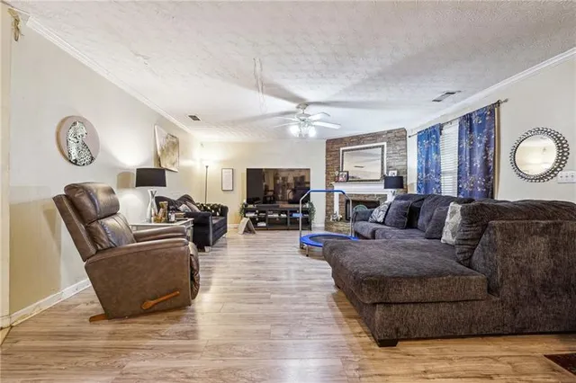 a living room with furniture wooden floor and window