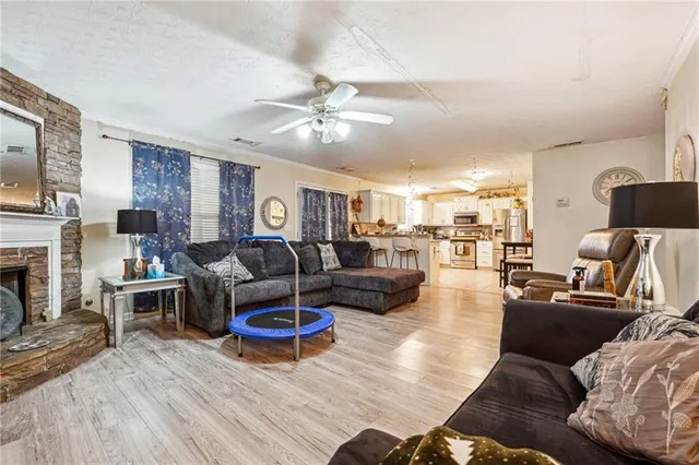 a living room with furniture kitchen view and a fireplace