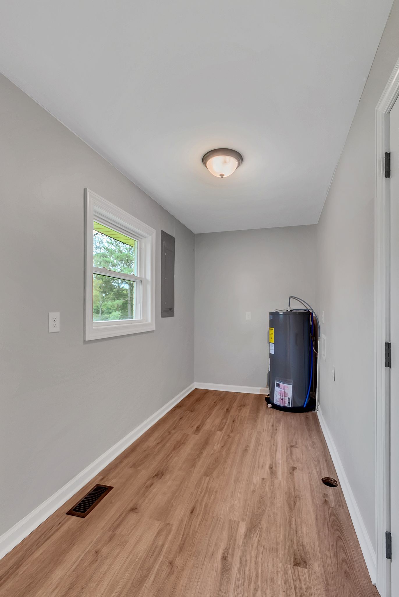 107 Horseshoe Bend Road Leoma, TN 38468 - Photo 15 of 35 a view of an empty room with wooden floor and a window