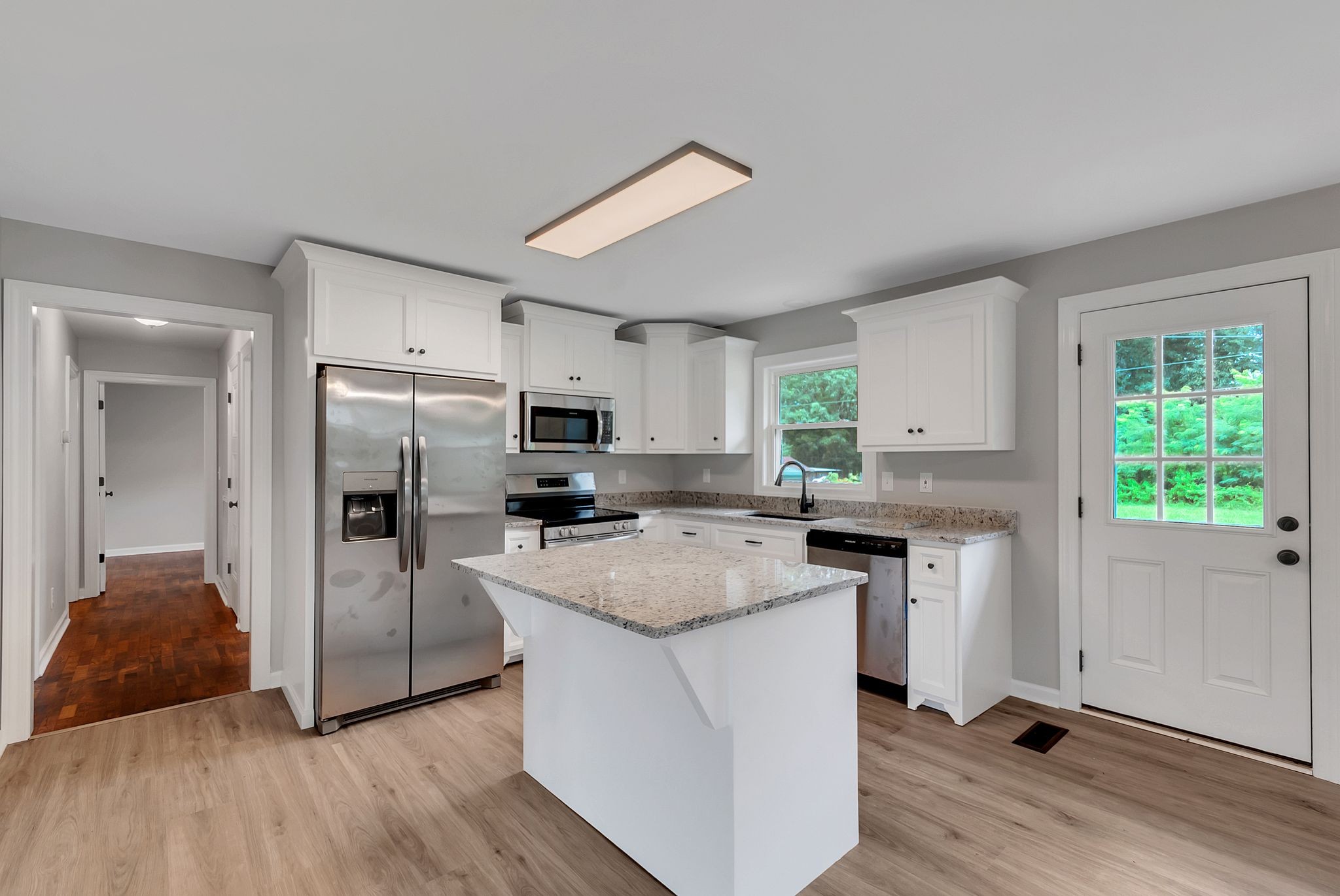 107 Horseshoe Bend Road Leoma, TN 38468 - Photo 16 of 35 a kitchen with refrigerator cabinets and wooden floor