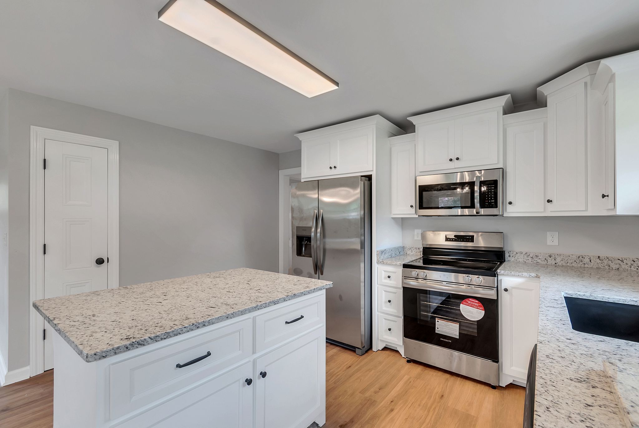 107 Horseshoe Bend Road Leoma, TN 38468 - Photo 17 of 35 a kitchen with granite countertop a stove cabinets and stainless steel appliances