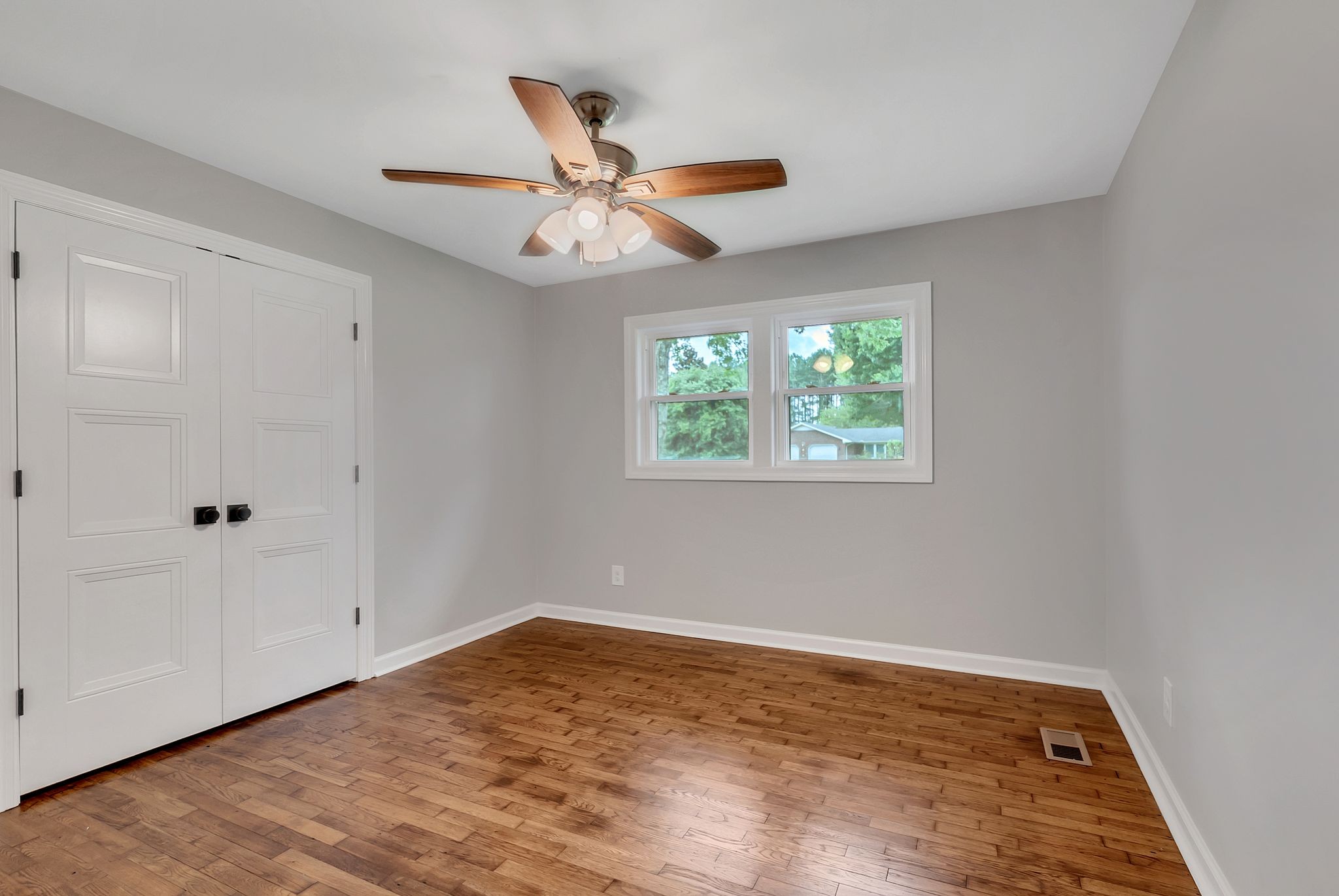 107 Horseshoe Bend Road Leoma, TN 38468 - Photo 20 of 35 an empty room with wooden floor fan and windows