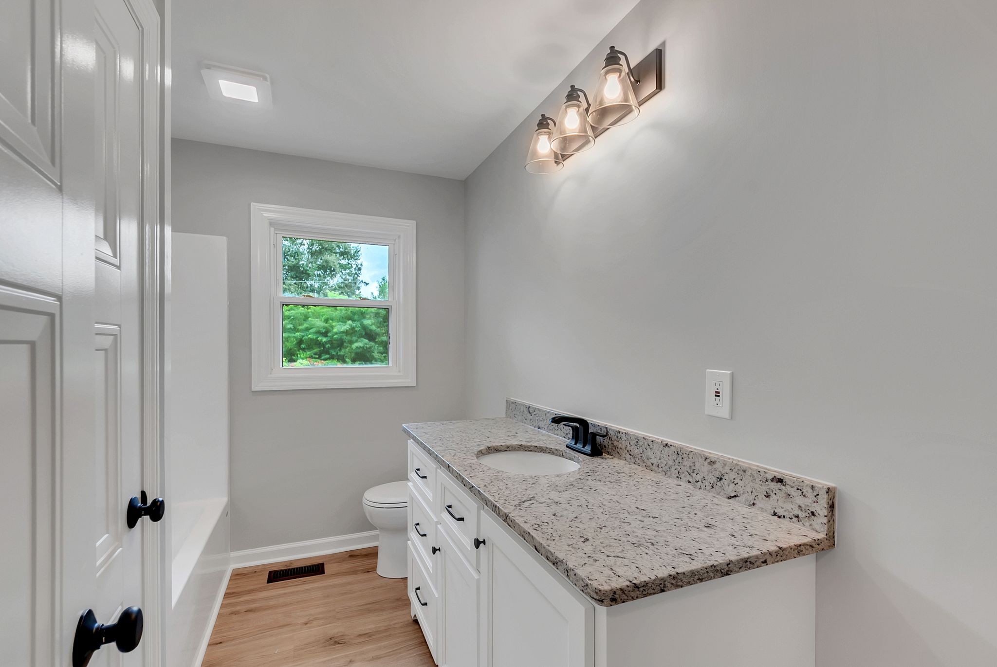 107 Horseshoe Bend Road Leoma, TN 38468 - Photo 22 of 35 a bathroom with a granite countertop sink a toilet and a mirror