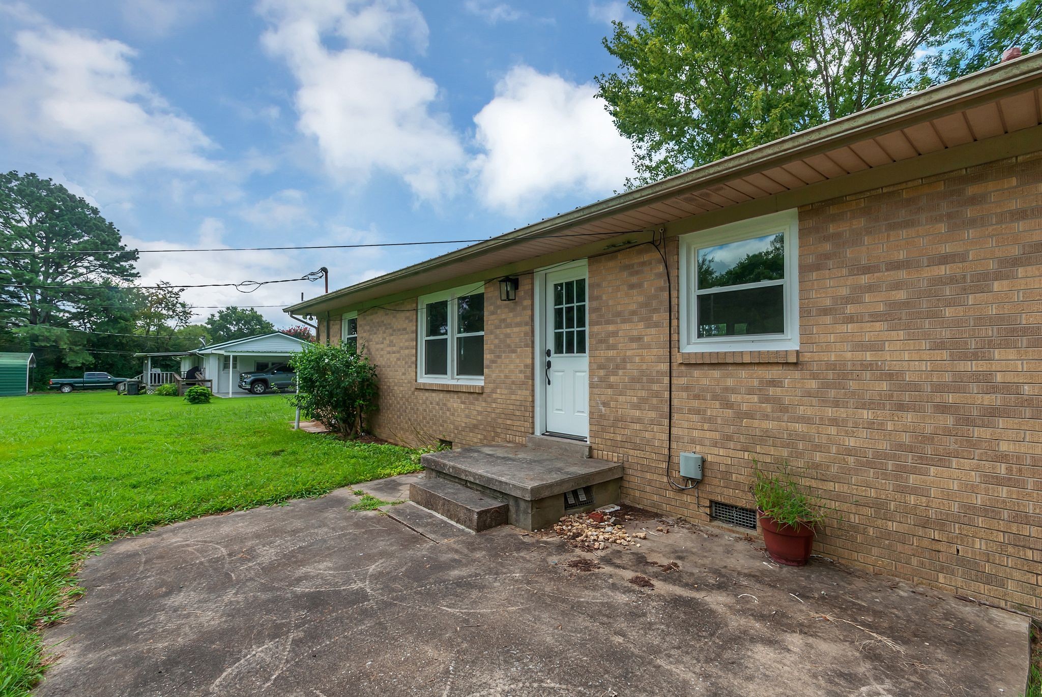 107 Horseshoe Bend Road Leoma, TN 38468 - Photo 30 of 35 a view of a backyard with plants and a patio