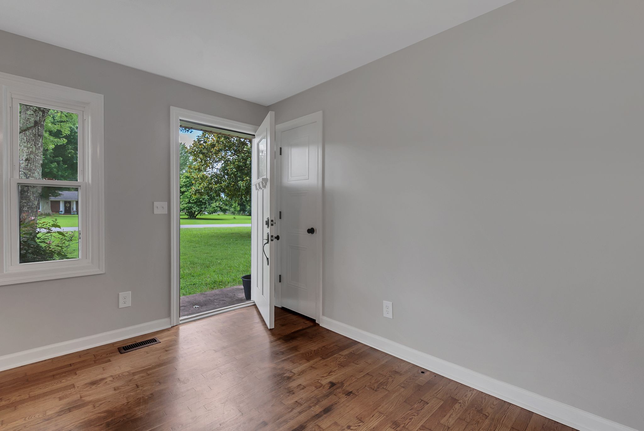 107 Horseshoe Bend Road Leoma, TN 38468 - Photo 9 of 35 an empty room with wooden floor and windows