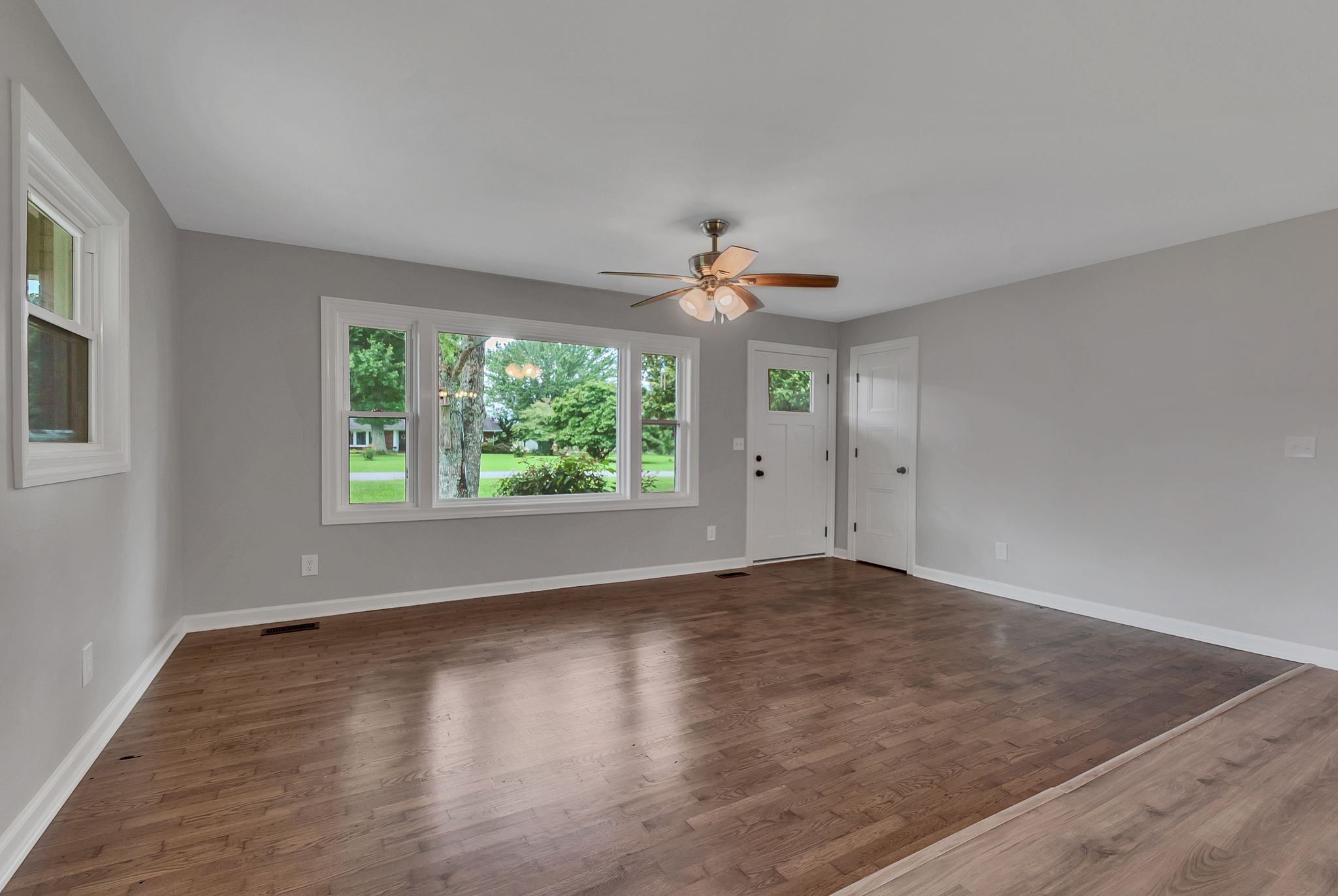107 Horseshoe Bend Road Leoma, TN 38468 - Photo 10 of 35 an empty room with wooden floor and windows