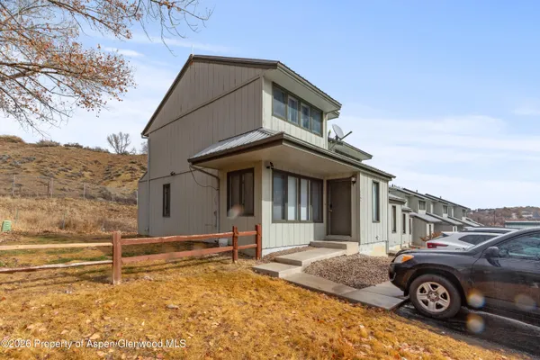 a front view of a house with parking space