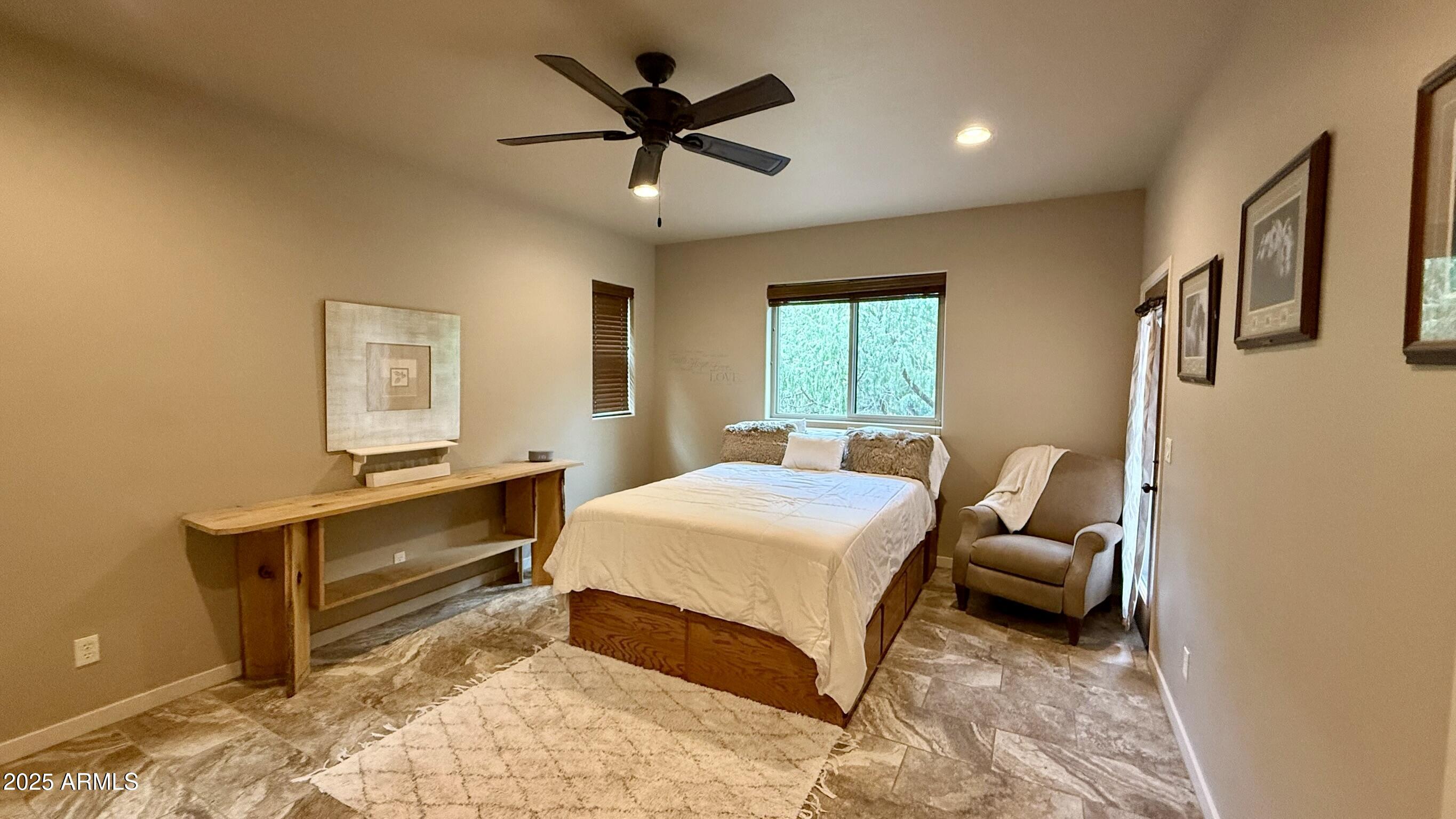 913 South Coronado Way Payson, AZ 85541 - Photo 14 of 52 a bedroom with a bed and a chandelier