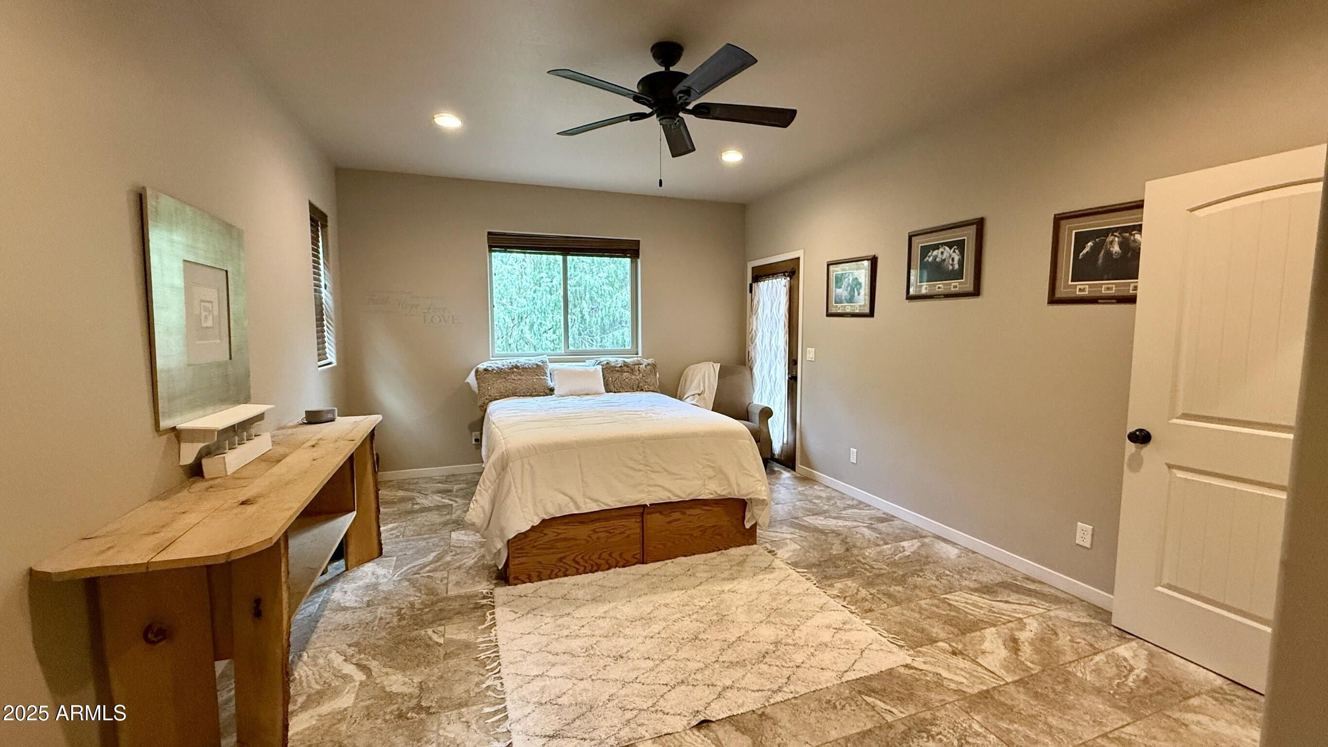 913 South Coronado Way Payson, AZ 85541 - Photo 15 of 52 a bedroom with a bed and a chandelier