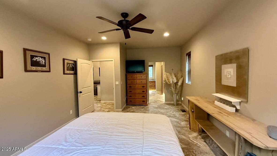 913 South Coronado Way Payson, AZ 85541 - Photo 16 of 52 a bedroom with a bed and a chandelier