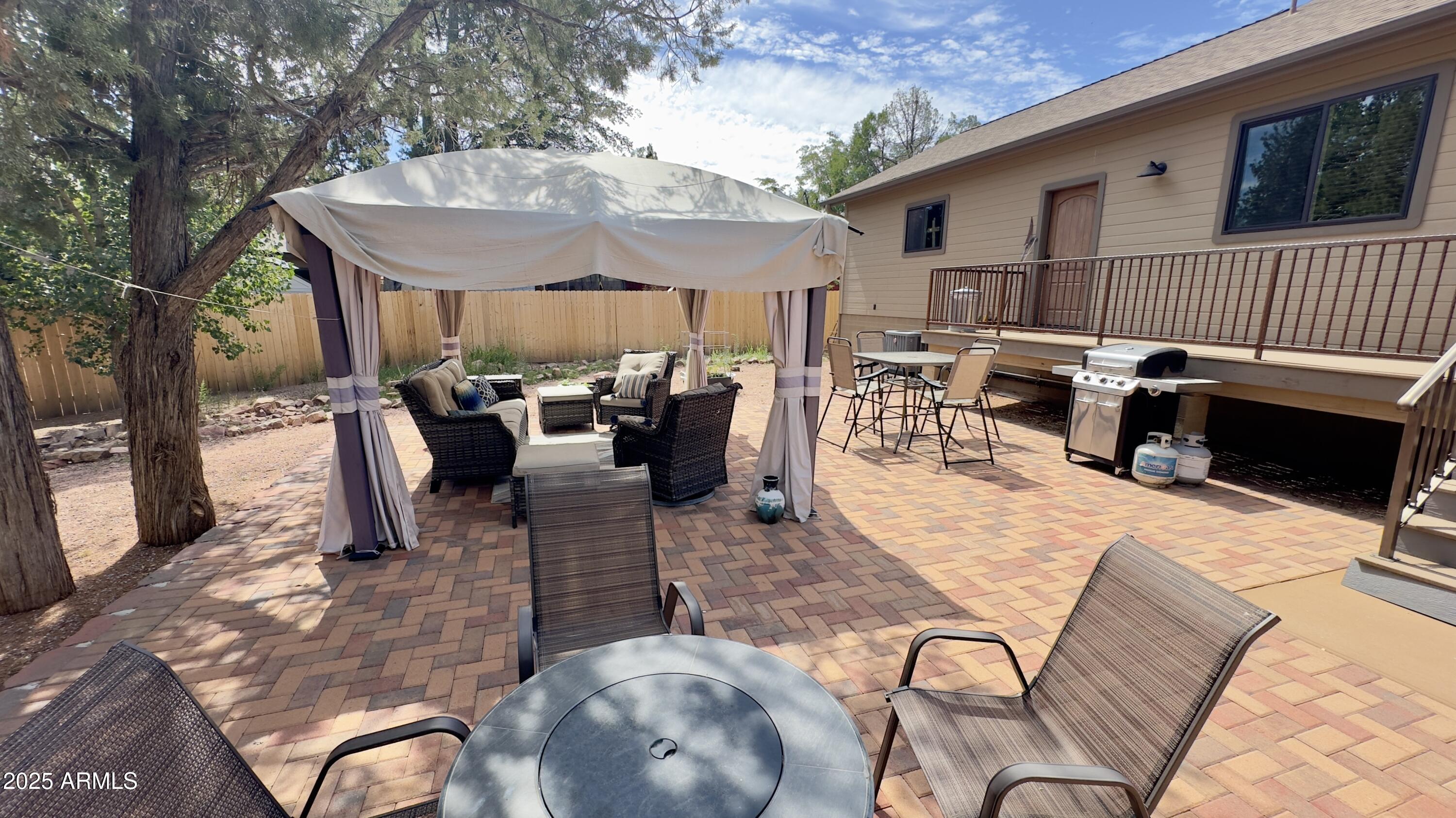 913 South Coronado Way Payson, AZ 85541 - Photo 45 of 52 a view of a patio with dining table and chairs with wooden floor and fence