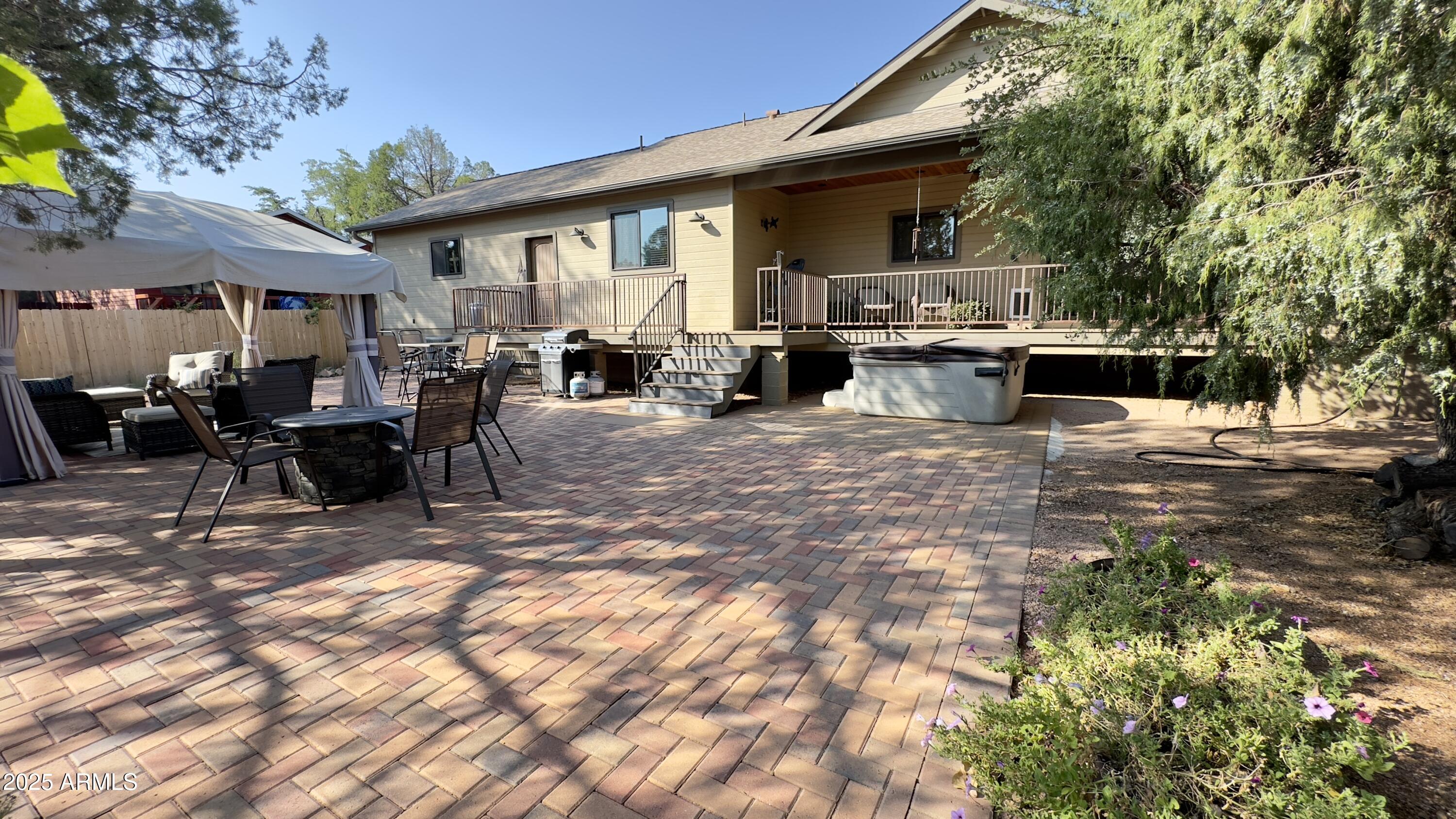 913 South Coronado Way Payson, AZ 85541 - Photo 47 of 52 a view of a patio with table and chairs potted plants and a large tree