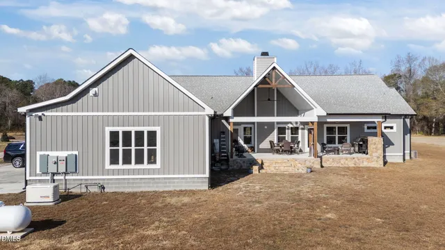 an aerial view of a house with outdoor space and swimming pool