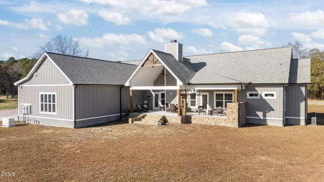 a view of a house with a yard and covered with snow in front of house