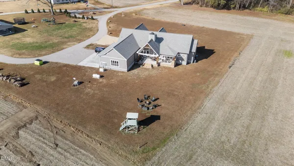 a view of a yard with plants and trees