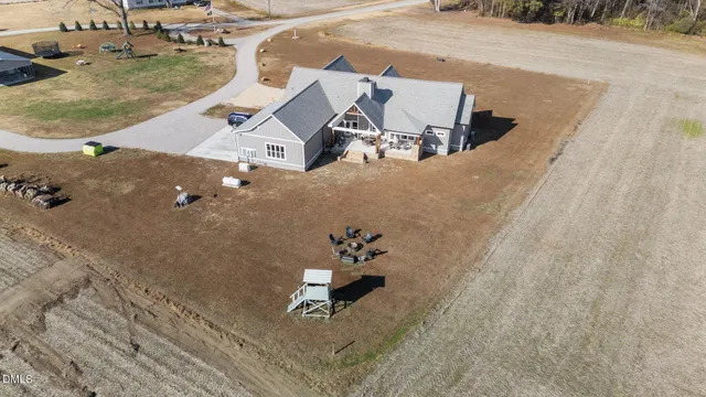 a view of a yard with plants and trees