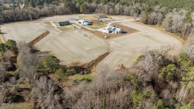 a view of a dining room with furniture a chandelier and wooden floor