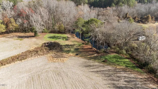 a kitchen with stainless steel appliances kitchen island granite countertop a dining table chairs refrigerator and sink