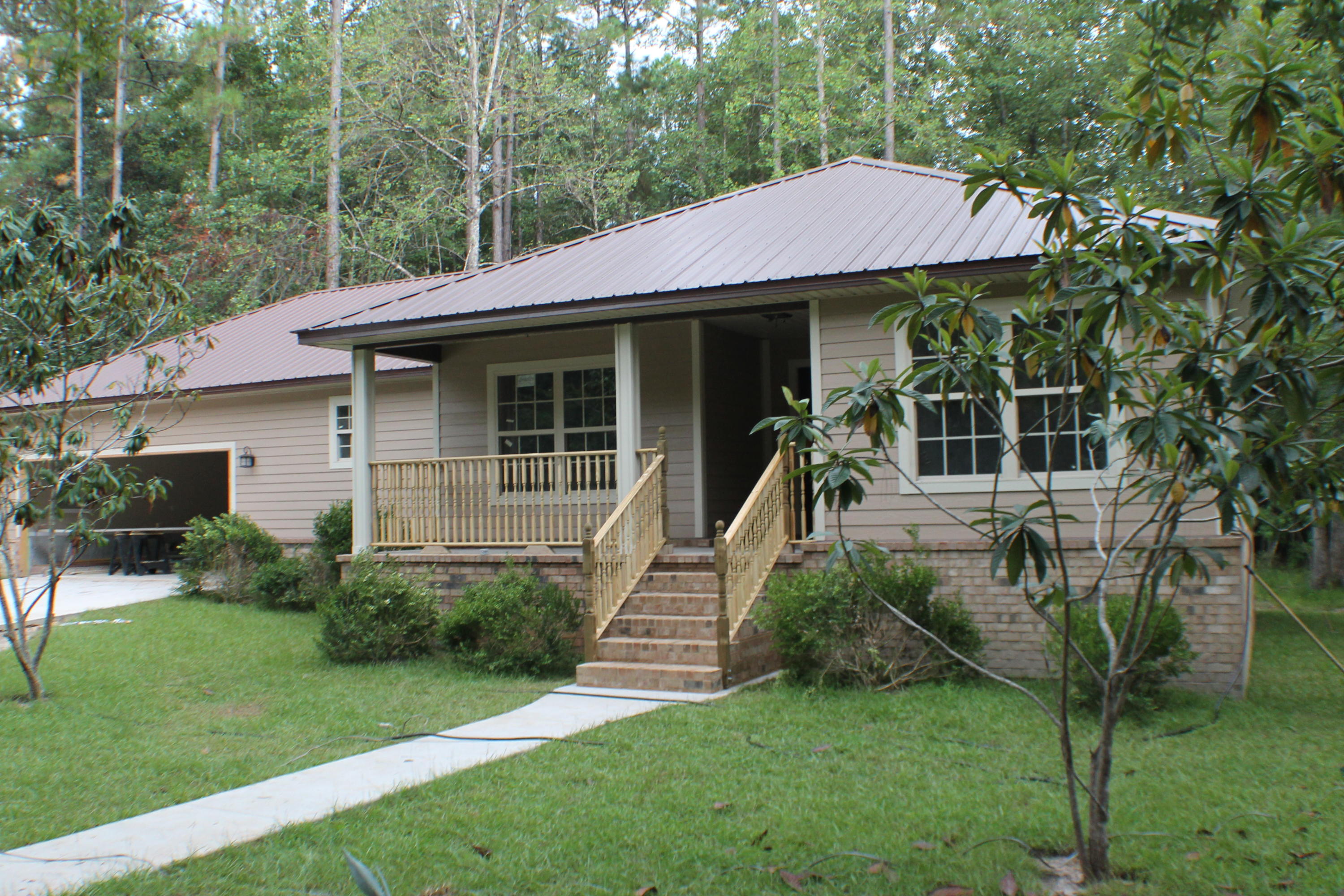 5588 Old Bethel Road Crestview, FL 32536 - Photo 1 of 42 a view of a house with a backyard and a patio