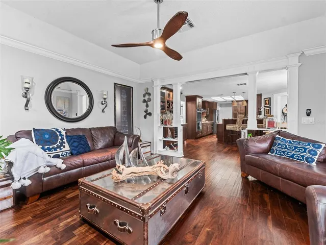 a living room with furniture and wooden floor