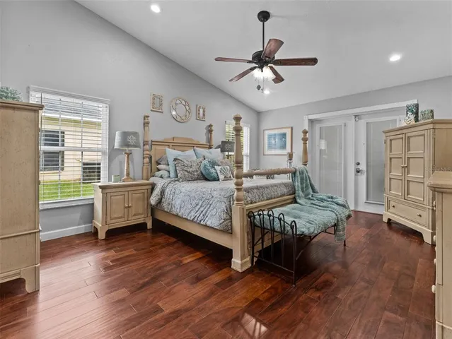 a bedroom with a large bed and a chandelier