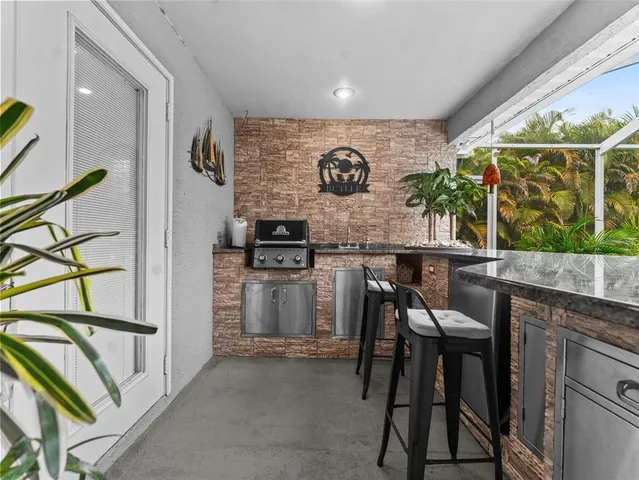 a view of a patio with table and chairs under an umbrella