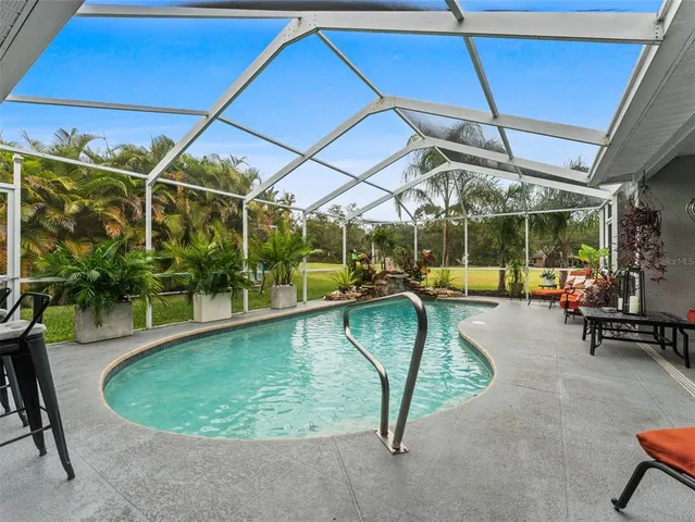 a view of a backyard with plants and patio