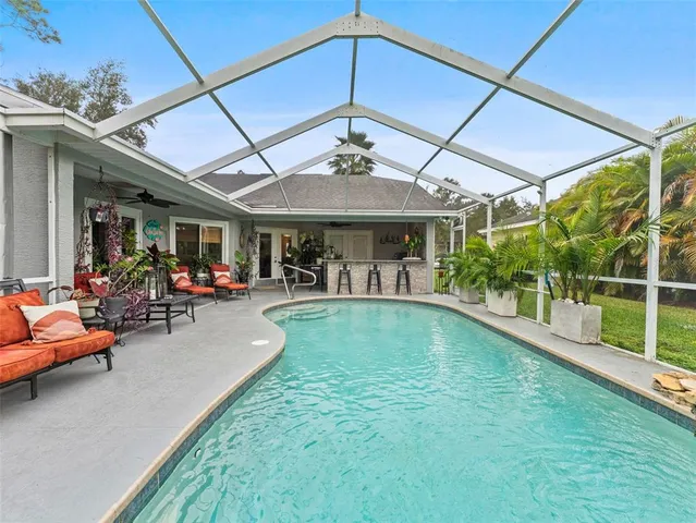 a view of a house with a big yard and large trees