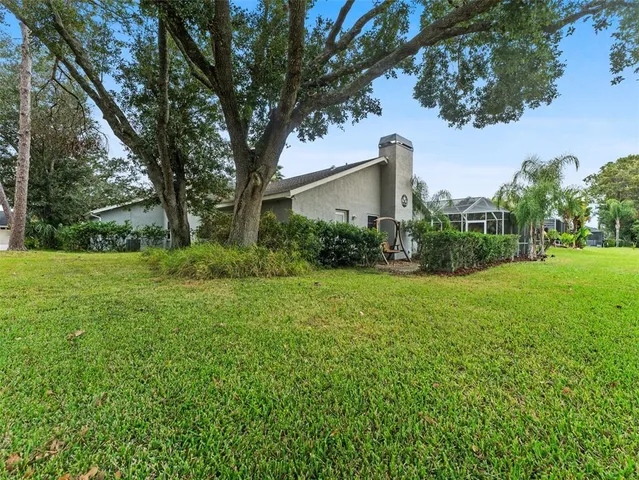 an aerial view of residential house with swimming pool and lawn chairs