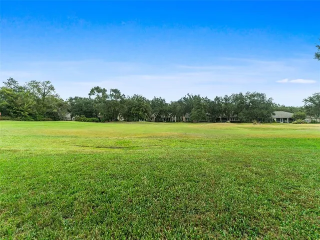 an aerial view of residential houses with outdoor space and swimming pool