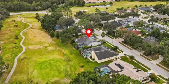 an aerial view of residential houses with outdoor space
