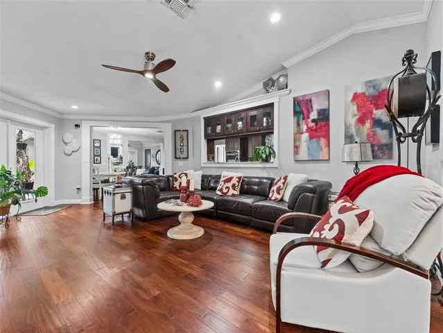 a living room with furniture kitchen and a window