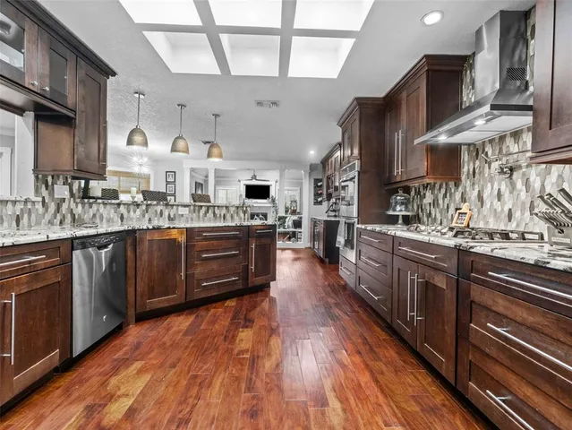 a kitchen with stainless steel appliances granite countertop a sink and cabinets