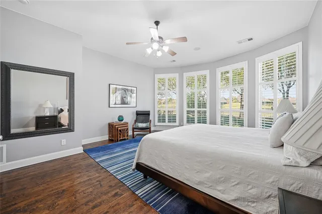 a bedroom with a large bed and a large window
