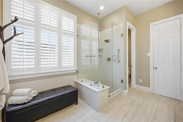 a bathroom with a tub shower and sink