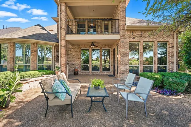 a view of a patio with a table and chairs and potted plants