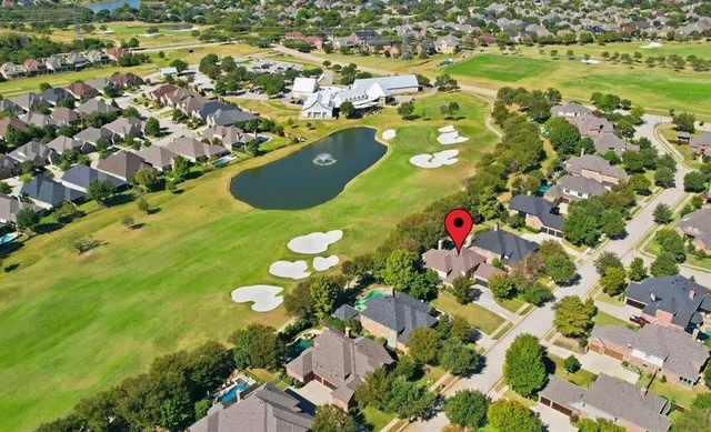 an aerial view of residential house with swimming pool and green space