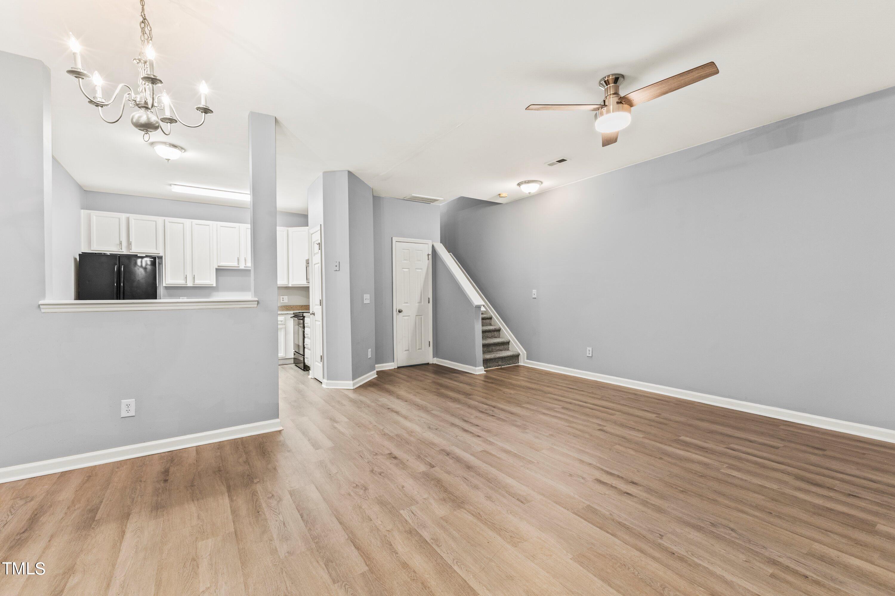 350 Gilman Lane, Unit 108 Raleigh, NC 27610 - Photo 11 of 34 wooden floor in an empty room with a window