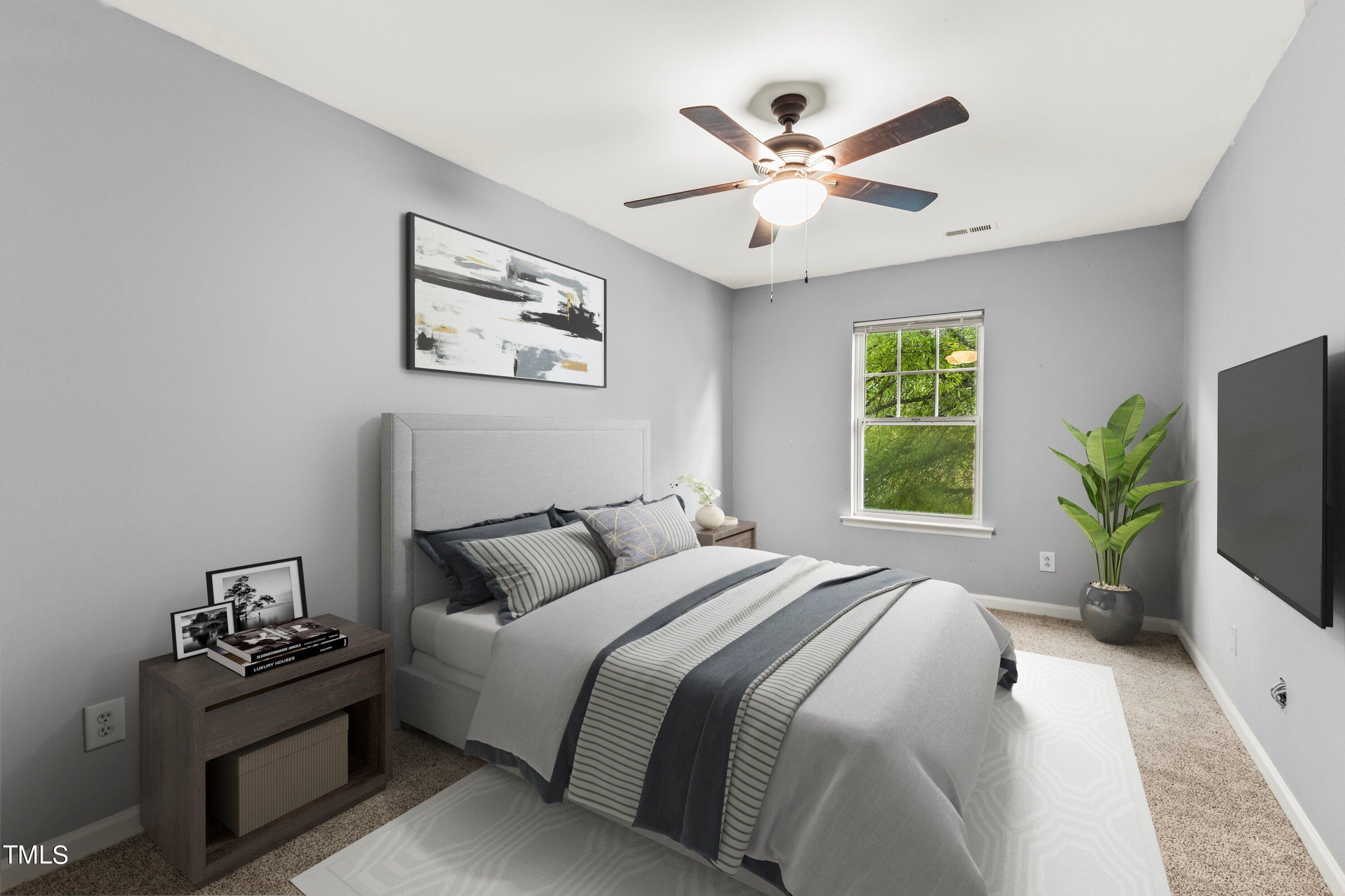 350 Gilman Lane, Unit 108 Raleigh, NC 27610 - Photo 17 of 34 a bedroom with a large bed and a chandelier