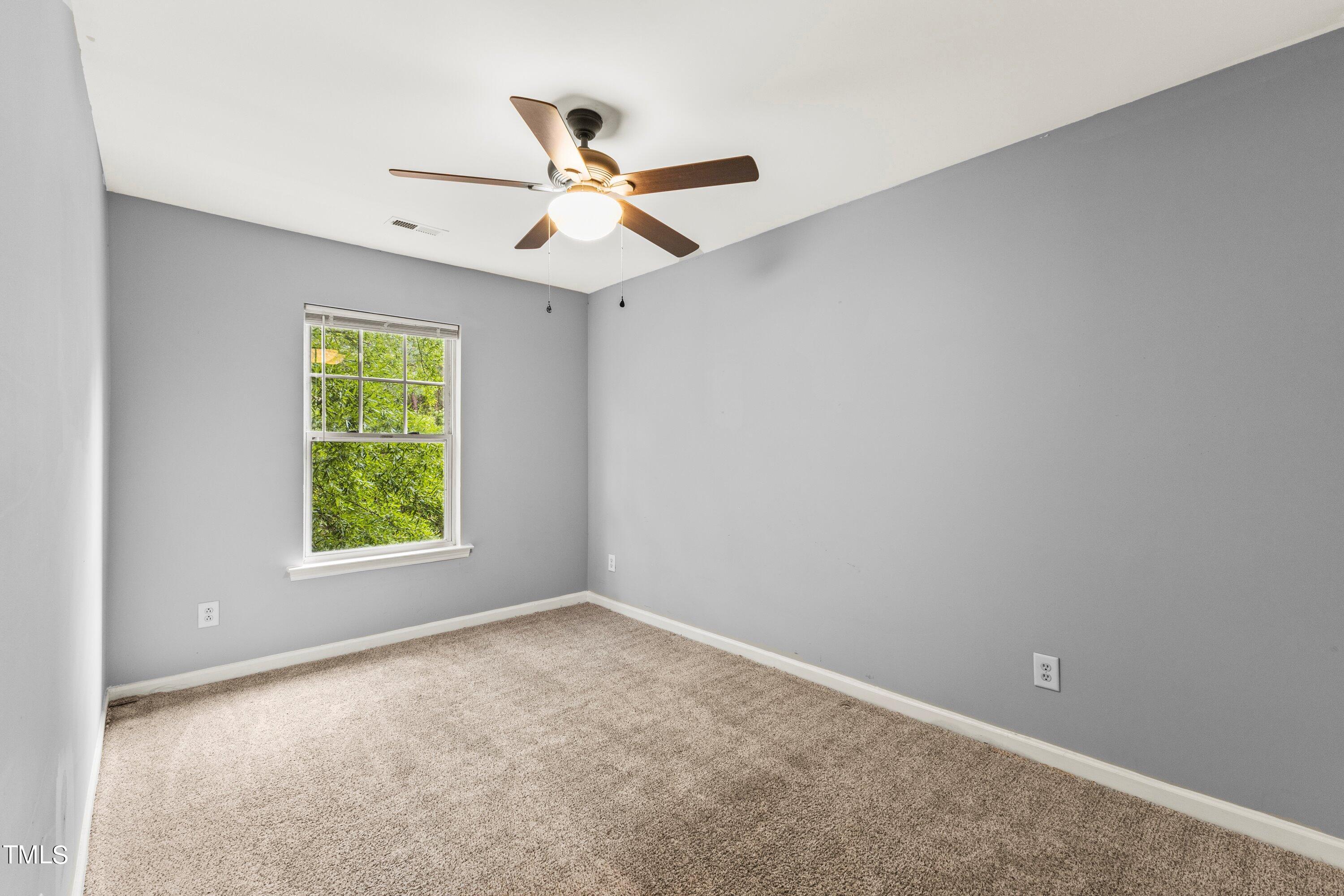 350 Gilman Lane, Unit 108 Raleigh, NC 27610 - Photo 19 of 34 an empty room with windows and fan