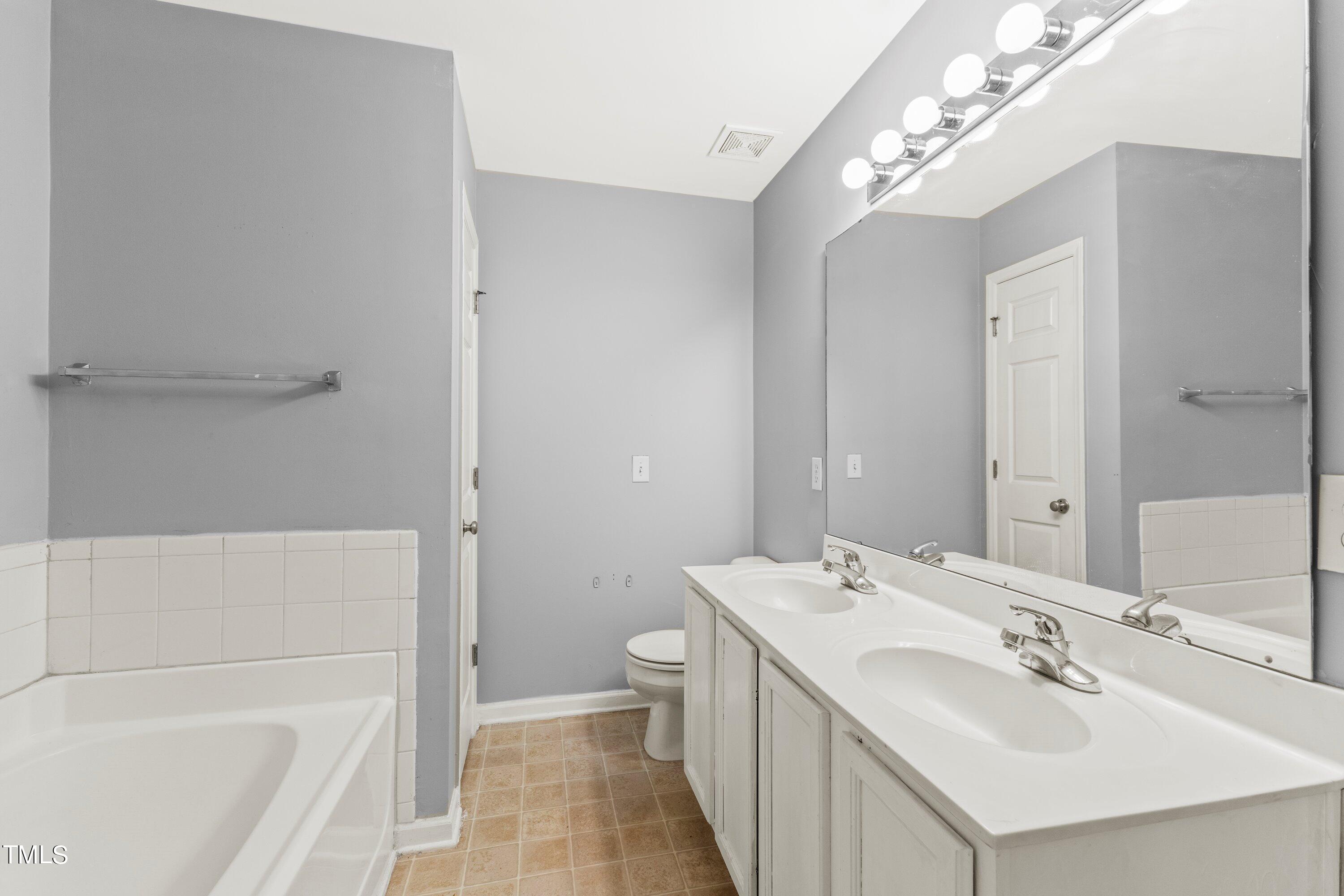 350 Gilman Lane, Unit 108 Raleigh, NC 27610 - Photo 20 of 34 a bathroom with a sink a toilet and shower