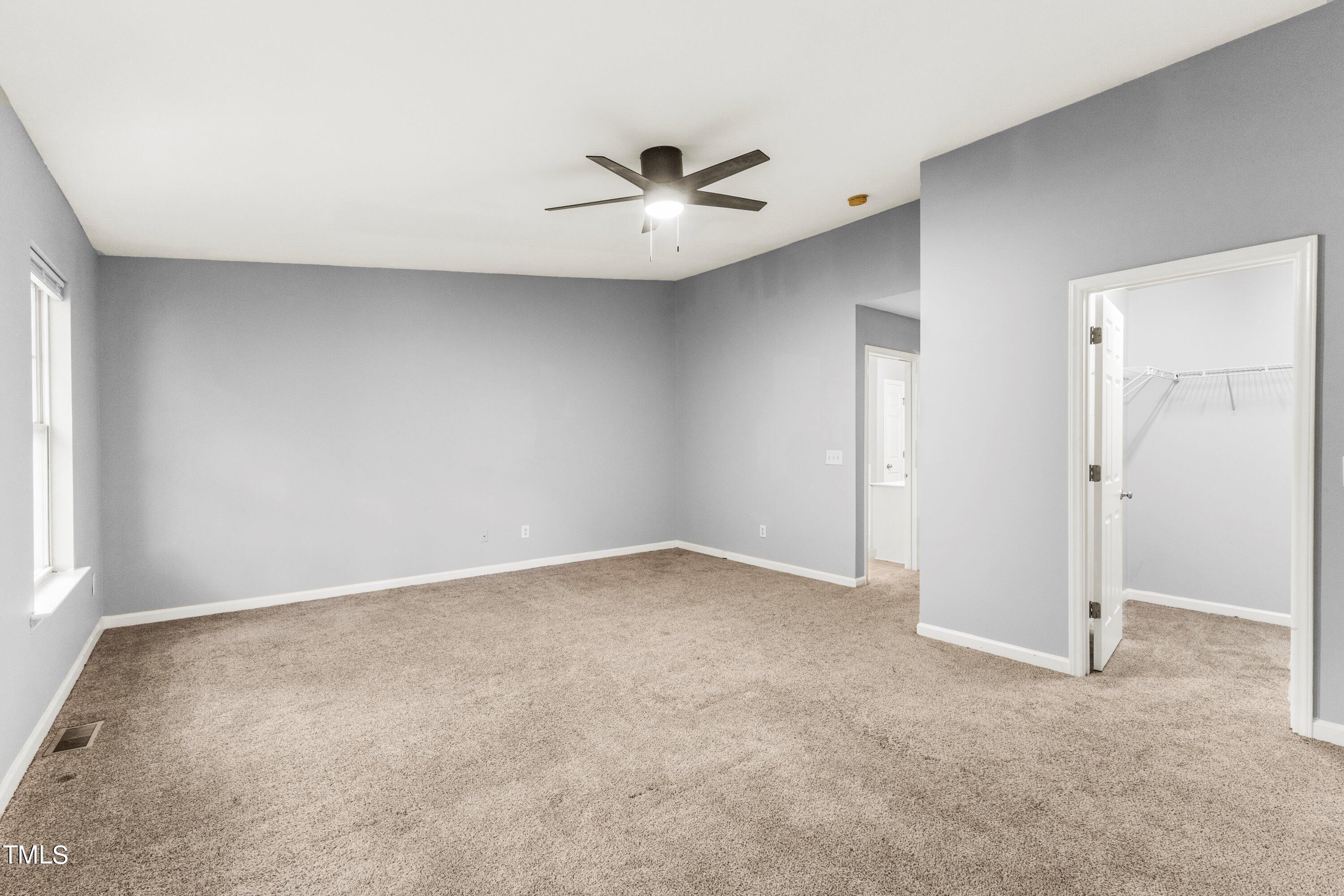 350 Gilman Lane, Unit 108 Raleigh, NC 27610 - Photo 28 of 34 an empty room with a ceiling fan and a window