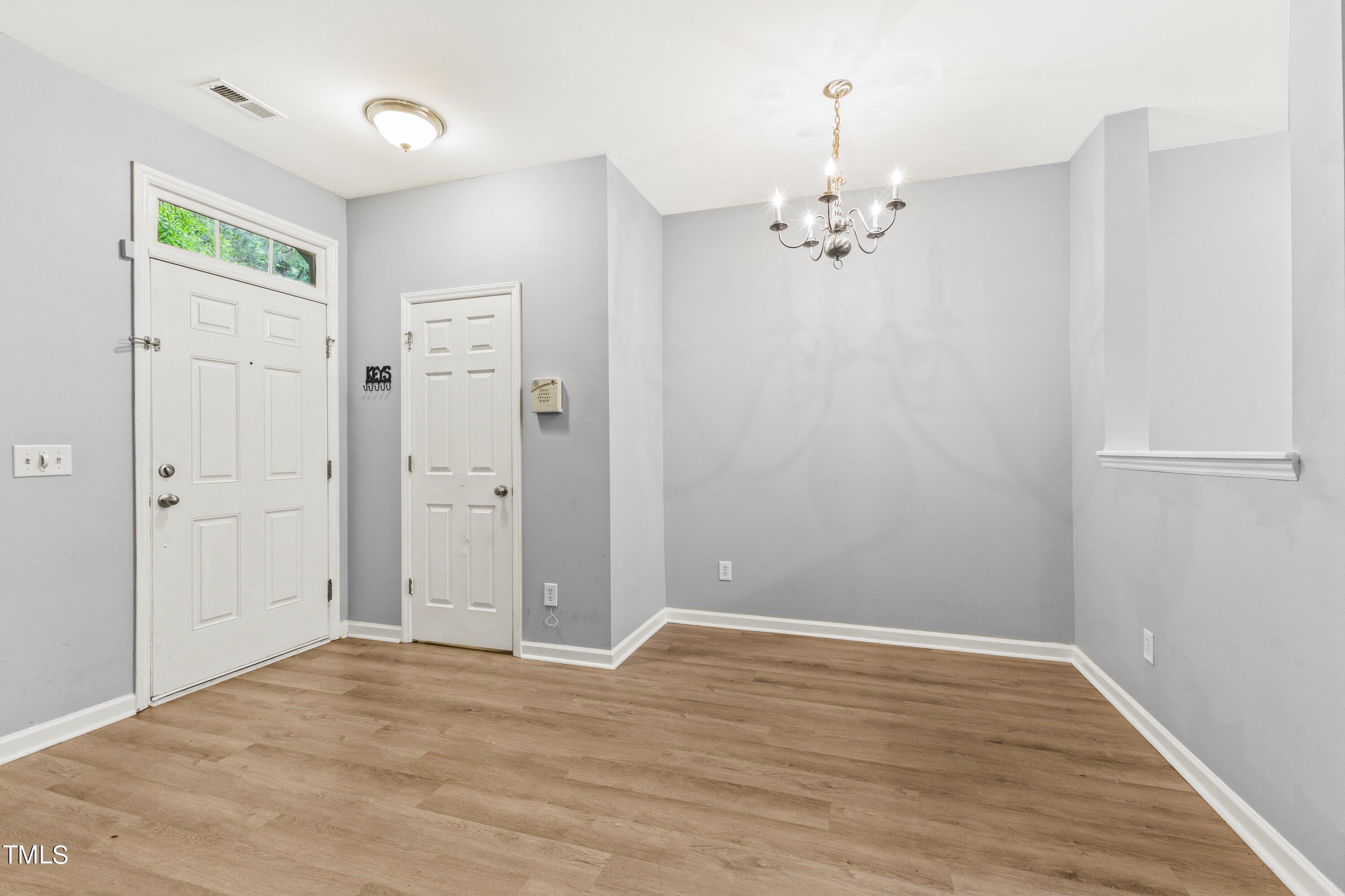 350 Gilman Lane, Unit 108 Raleigh, NC 27610 - Photo 4 of 34 wooden floor in an empty room with a window