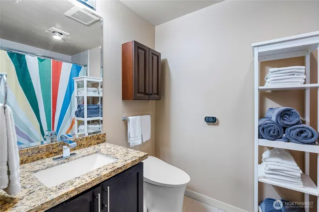 a bathroom with a sink a toilet and a mirror